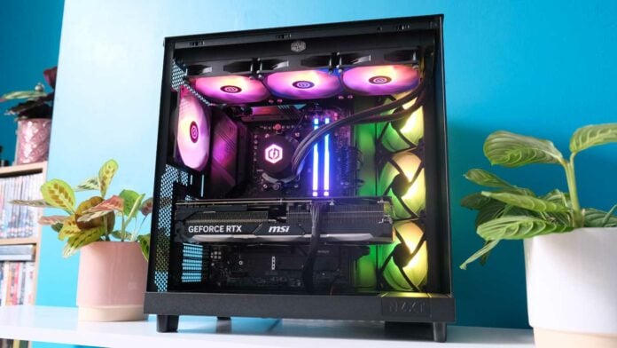 CyberpowerPC UK Ultra R77 RTX gaming PC against a teal wall.