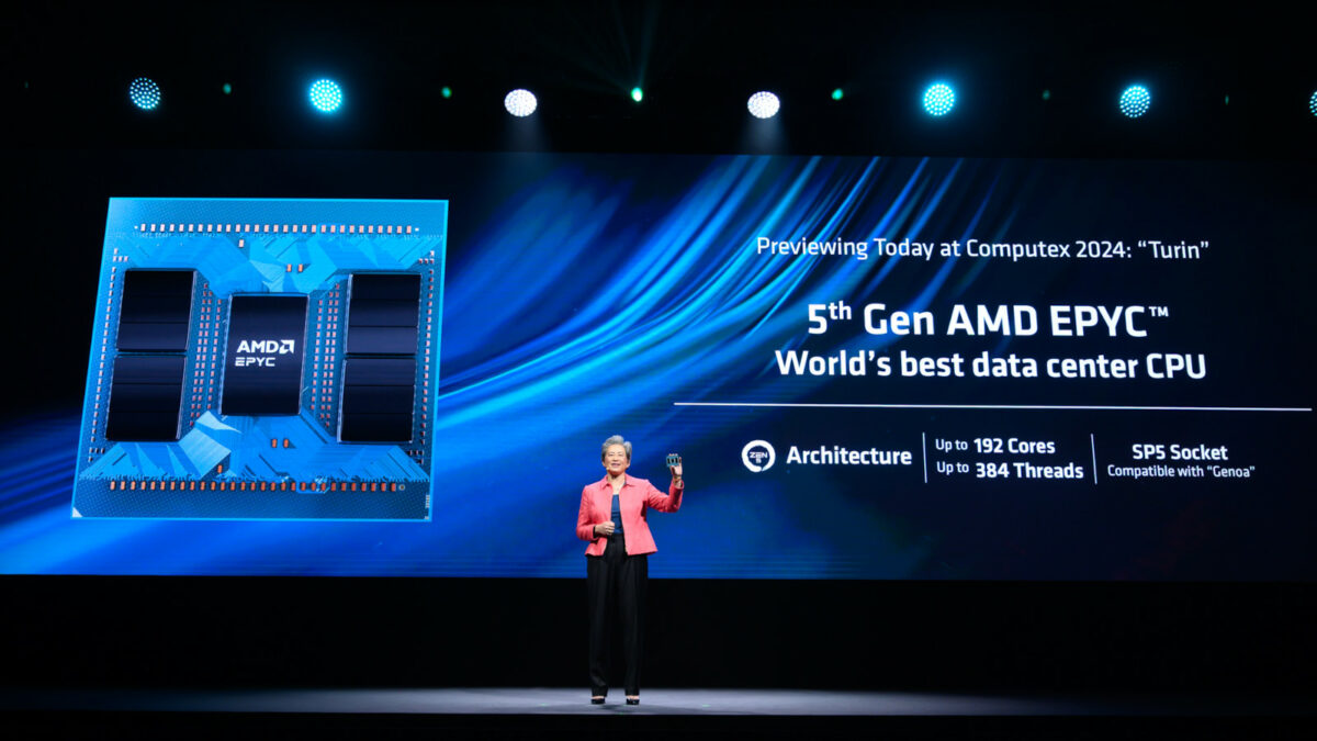 AMD CEO Dr. Lisa Su standing on stage at Computex, with a 5th Gen AMD EPYC slide behind her