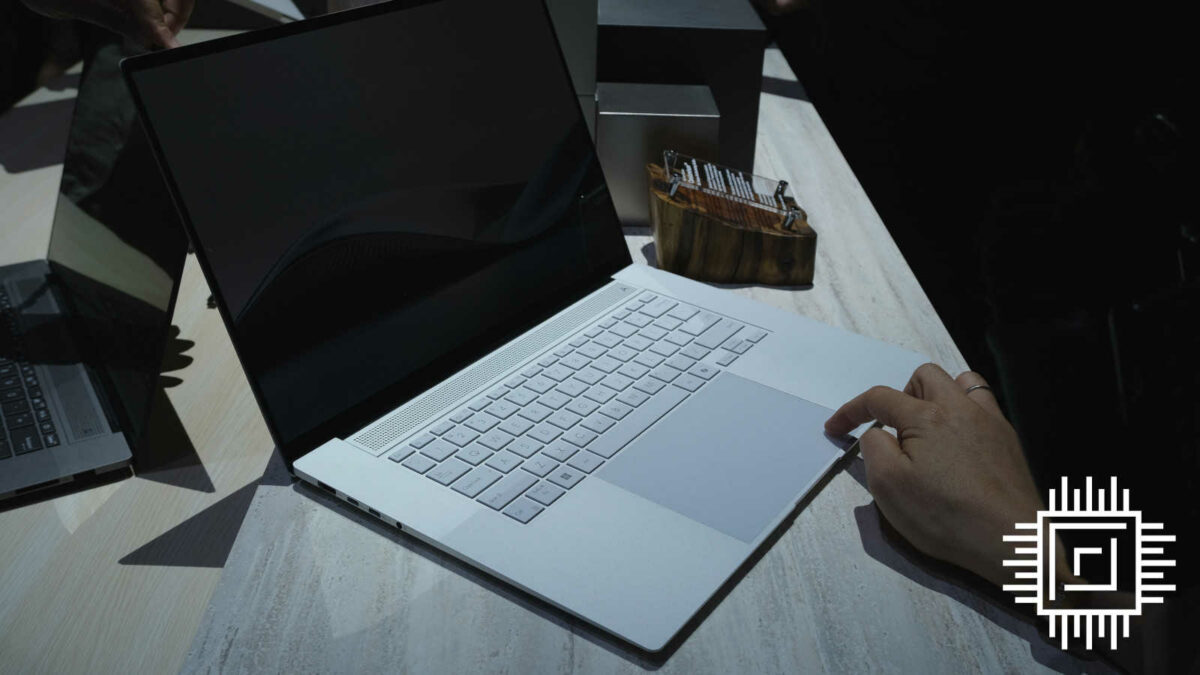 A hand uses the trackpad on Zenbook S 16