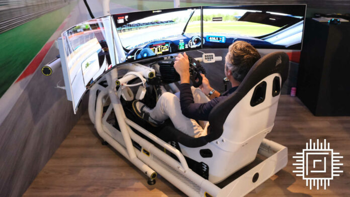 A person sat in Corsair's racing sim prototype, in a triple monitor setup