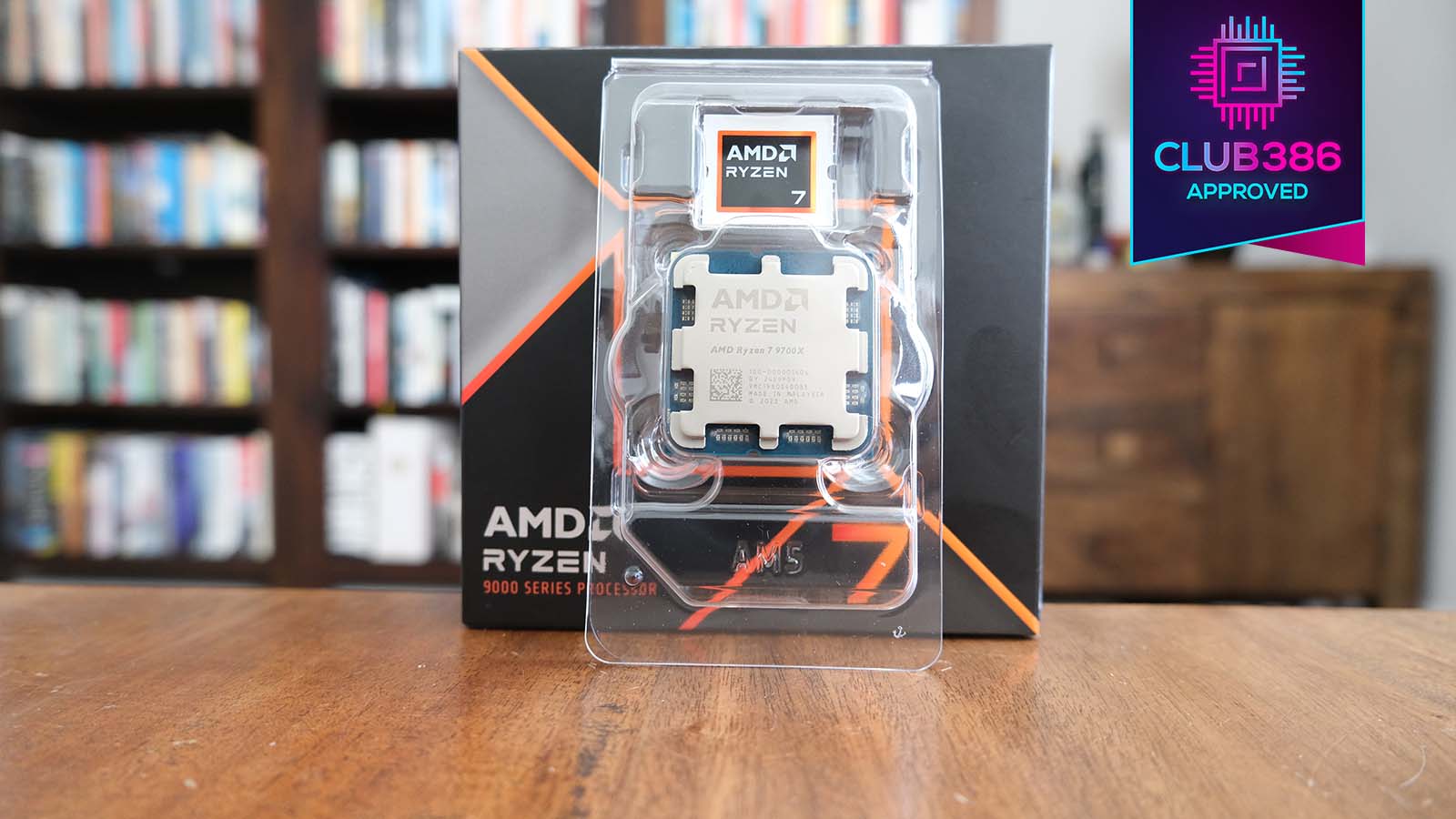 A picture of the Ryzen 7 9700X in its protective casing, flanked by a Club386 Approved award.