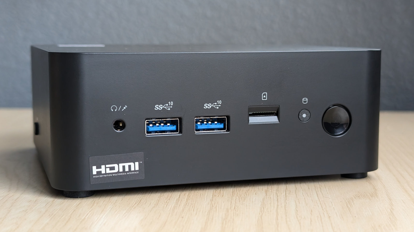 Front view of MSI Cubi NUC 1M, showcasing an array of ports and its power button.