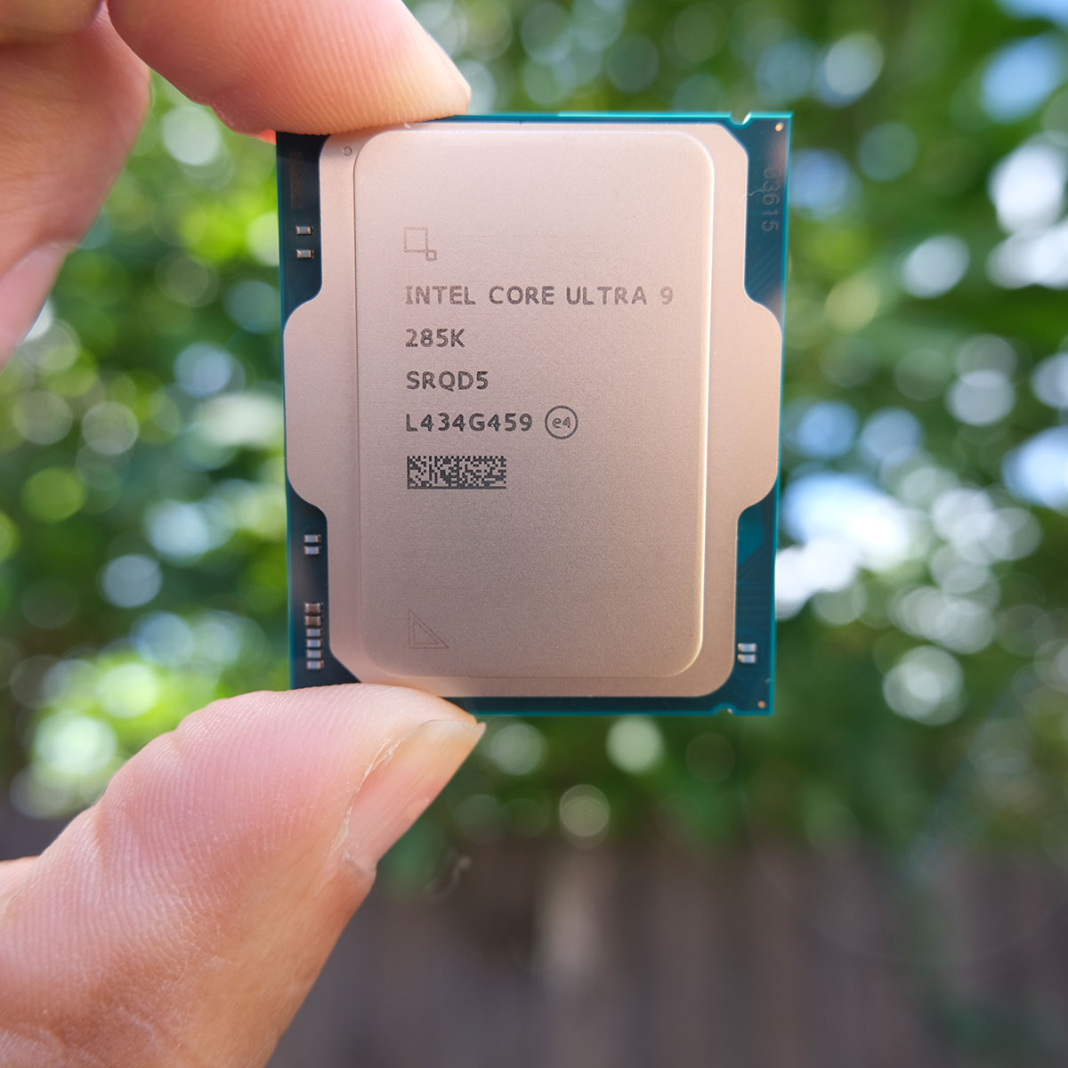 A picture of the Core Ultra 9 285K with greenery in the background.