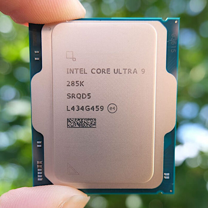 Core Ultra 9 285K processor, held between two fingers (top and bottom), against an out of focus green background.