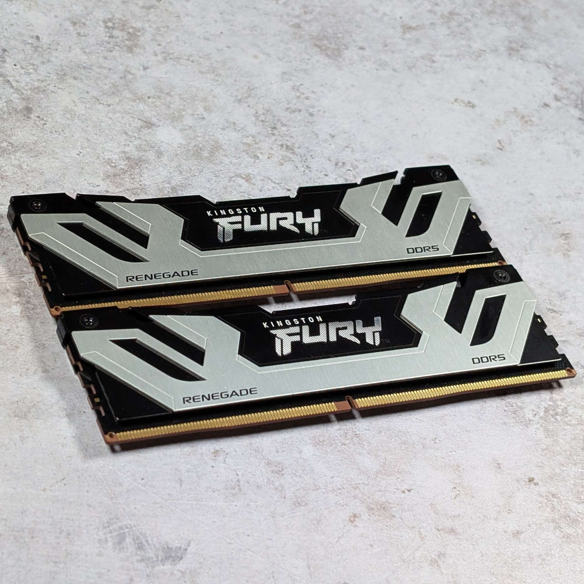 Kingston Fury Renegade DDR5 CUDIMM modules stacked vertically, against a white backdrop.