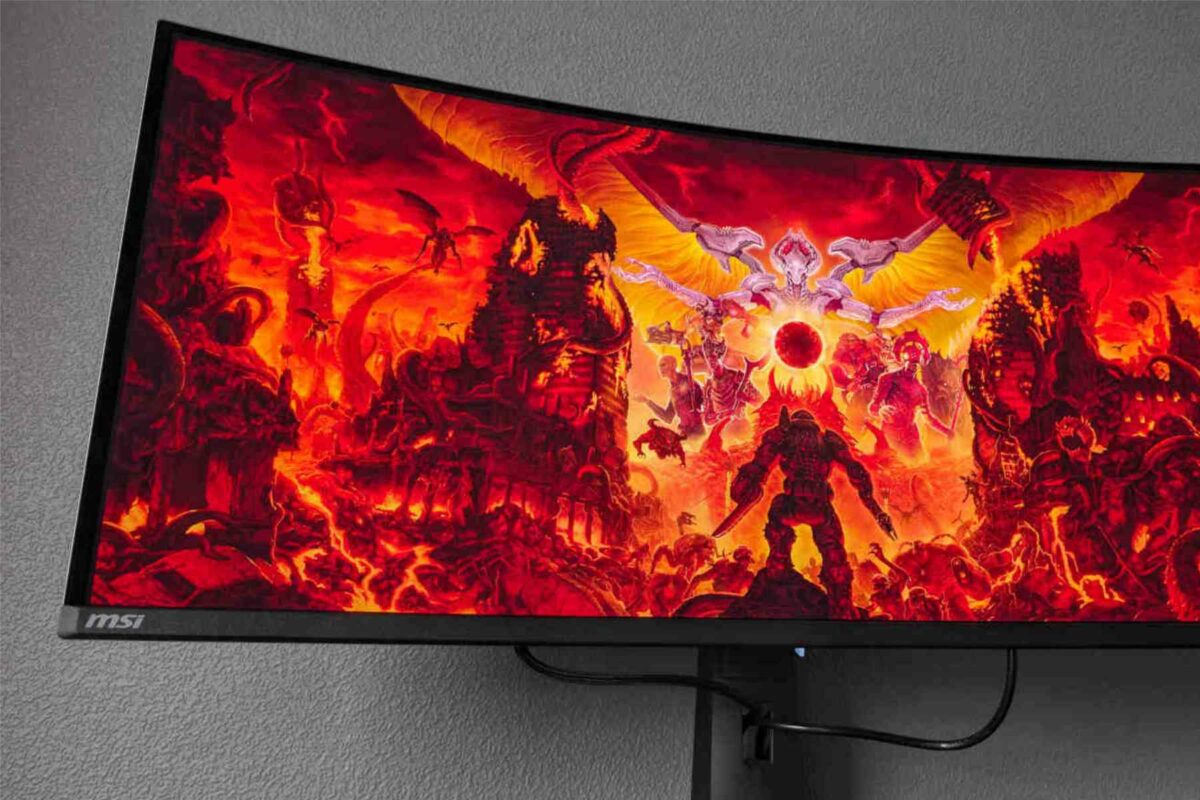 MSI MPG 341CQPX QD-OLED gaming monitor with red PC background.