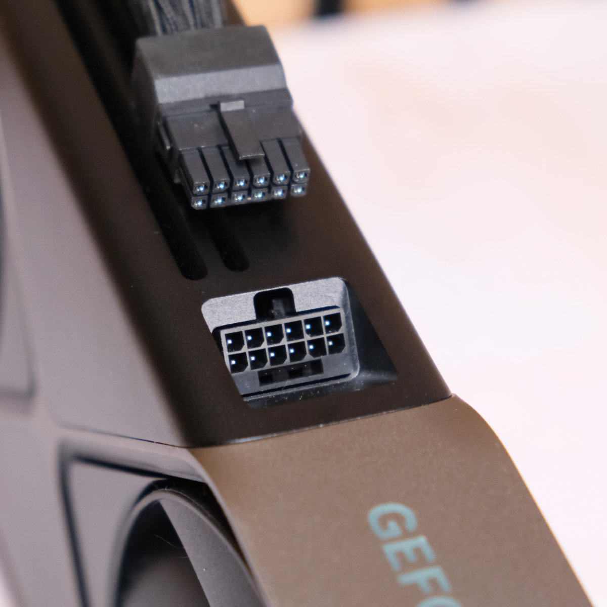 Nvidia GeForce RTX 5080 Founders Edition 16-pin connector with cable on top.