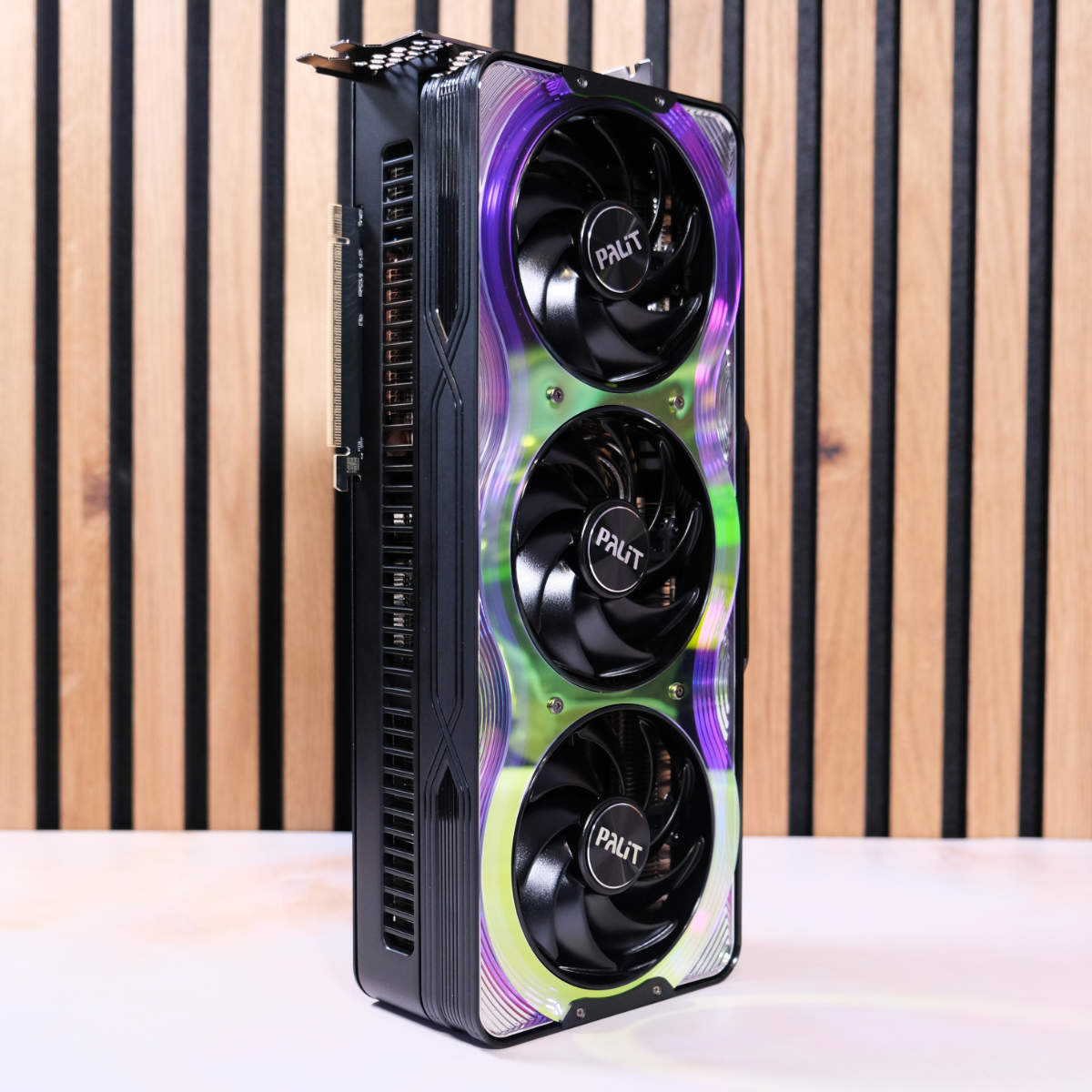 Palit GeForce RTX 5080 GameRock stands tall against wood panels.