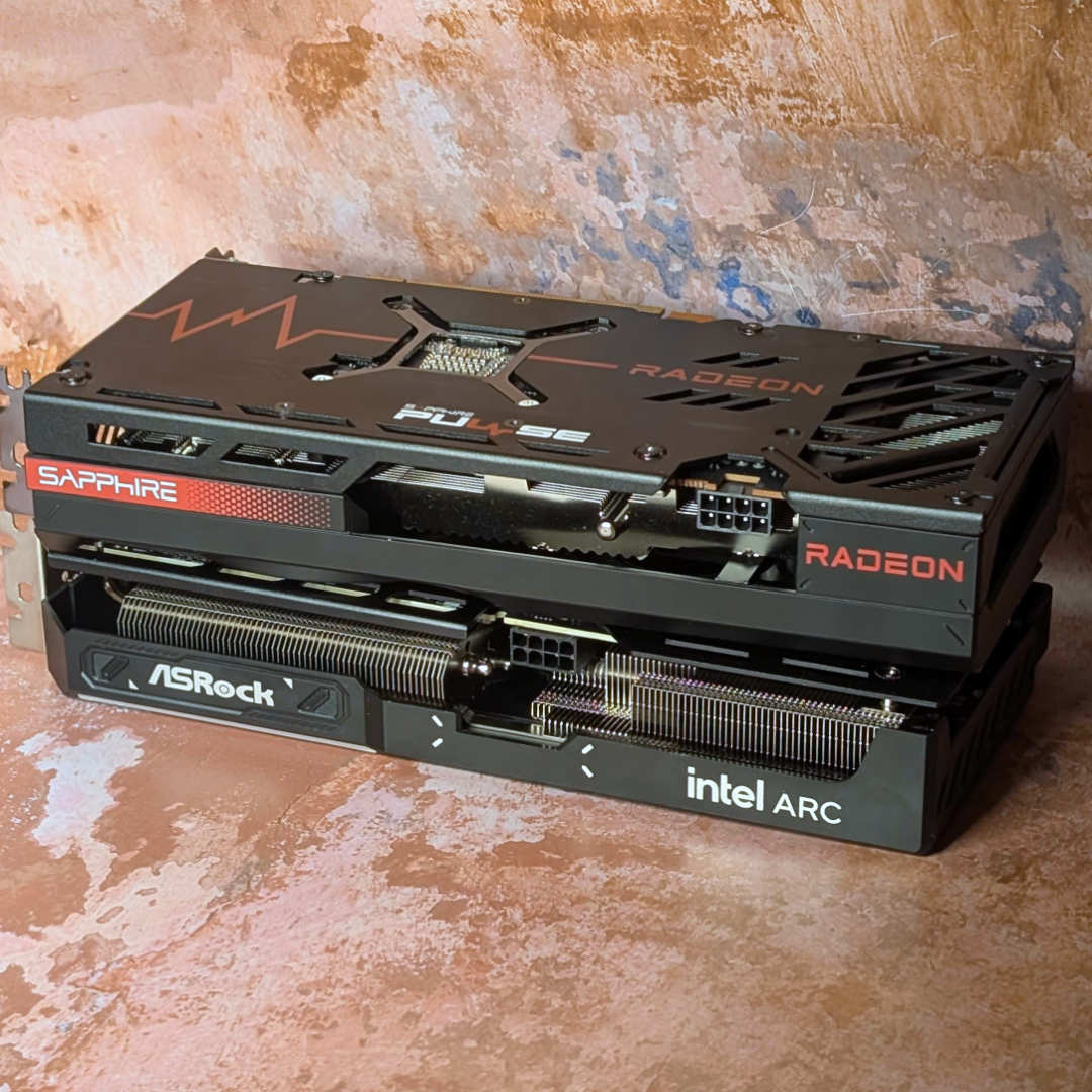 AMD Radeon RX 7600 stacked on top of an Intel Arc B570 graphics card.