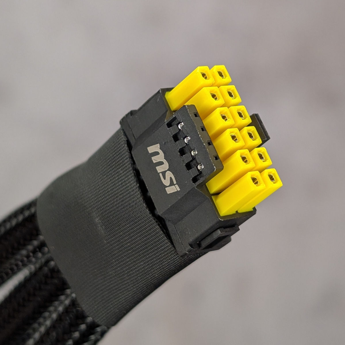 12-pin adapter as bundled with MSI GeForce RTX 5080 Vanguard, focussing on its yellow-tipped connectors.