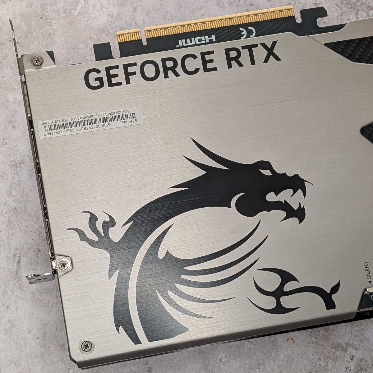 Metal backplate of GeForce RTX 5080 Vanguard, featuring MSI's dragon logo in black.