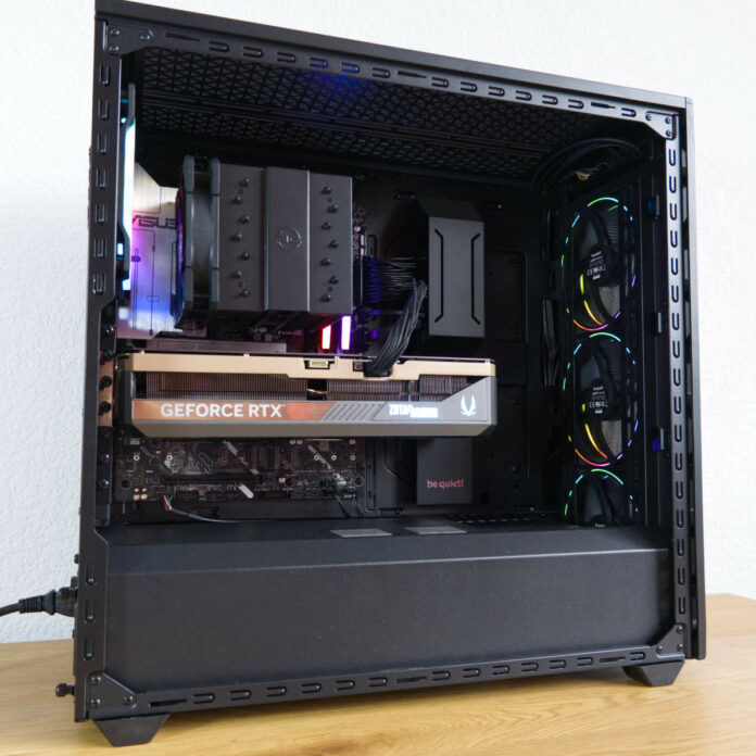 Wide shot of PCSpecialist Nebula Ultra R, atop a wooden surface against a white backdrop.