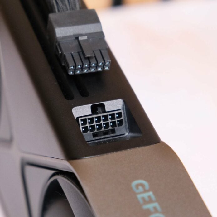 Close up of GeForce RTX 5080 Founders Edition, focussing on its 16-pin power connector, with a cable resting above it (top).