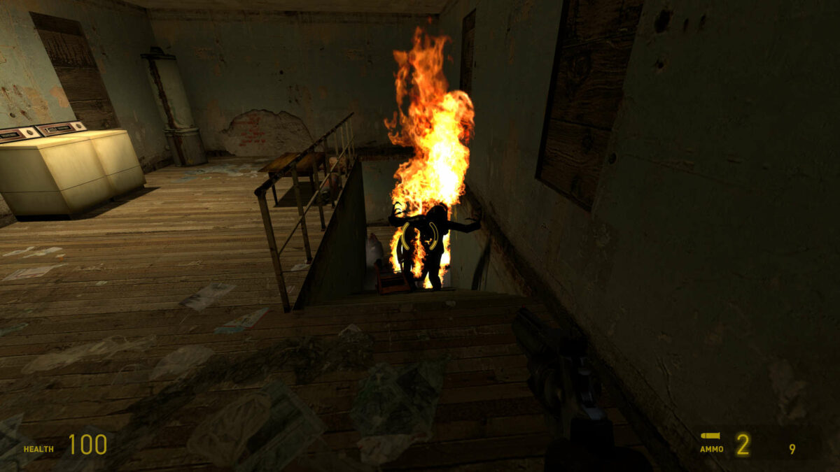 Headcrab zombies shuffle up a staircase, screaming as they burn in Half-Life 2.